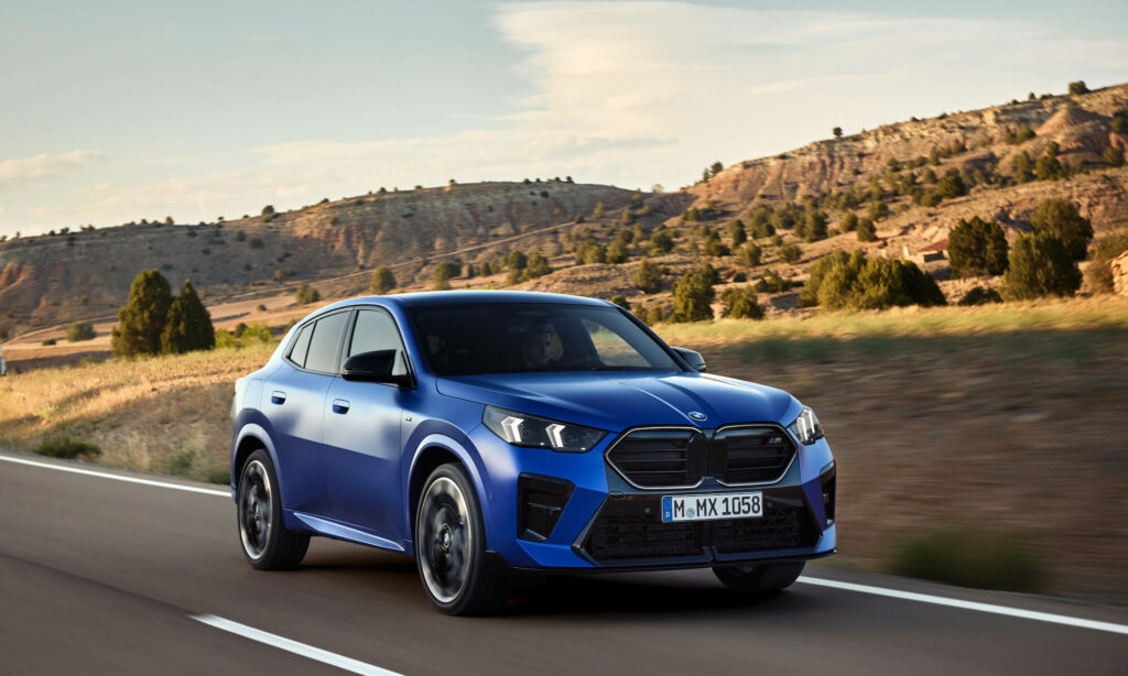 Blue 2024 BMW X2 driving on road